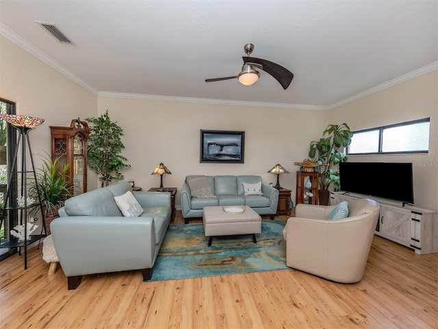 living room with light hardwood / wood-style floors, crown molding, and ceiling fan