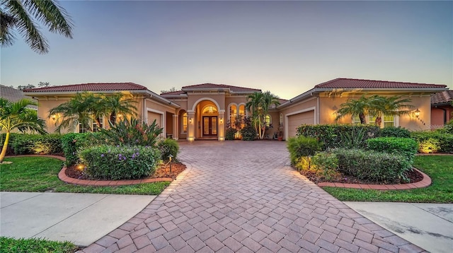 mediterranean / spanish-style home featuring a garage