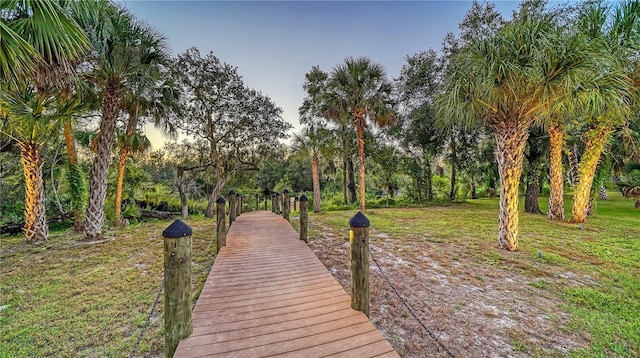 view of dock with a lawn