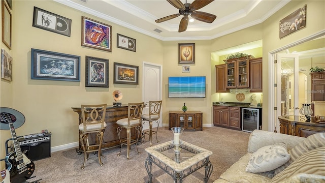 bar featuring light carpet, ceiling fan, beverage cooler, and ornamental molding