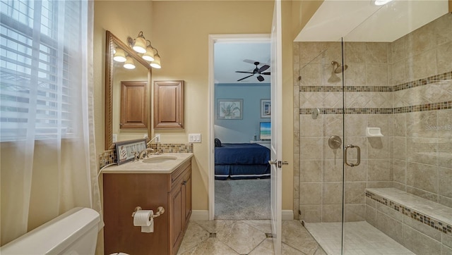 bathroom featuring ceiling fan, an enclosed shower, and vanity