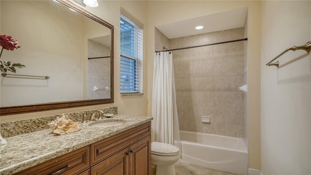 full bathroom featuring shower / tub combo, vanity, and toilet