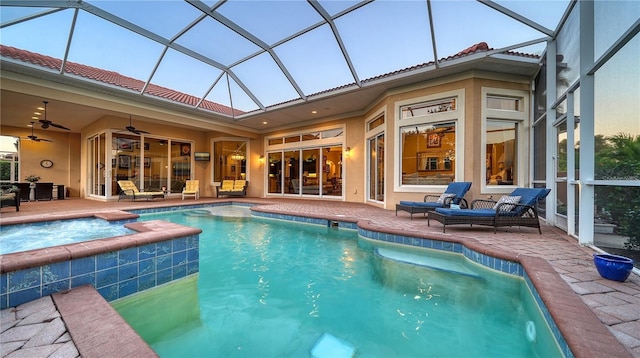 view of pool featuring ceiling fan, a patio, and glass enclosure