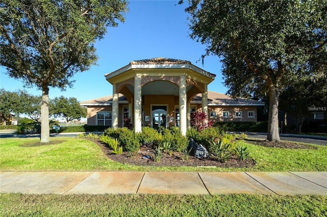 view of front of house with a front yard and covered porch