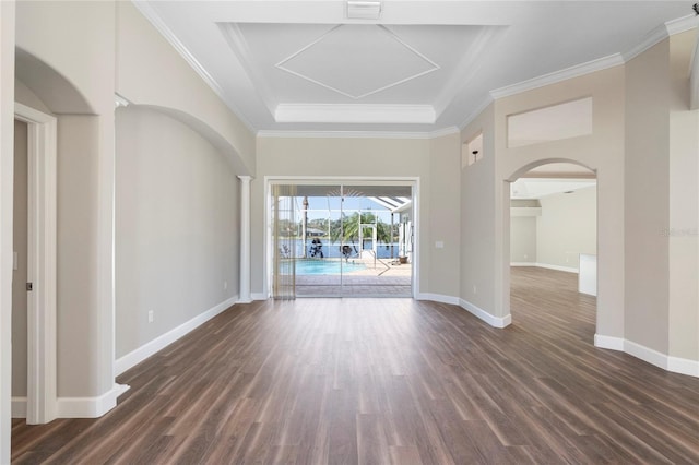 11332 Rivers Bluff Cir, Lakewood Ranch, FL 34202 - spare room featuring arched walkways, dark wood-style flooring, ornamental molding, and baseboards