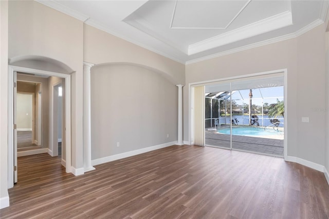 empty room with ornate columns, crown molding, and dark hardwood / wood-style floors