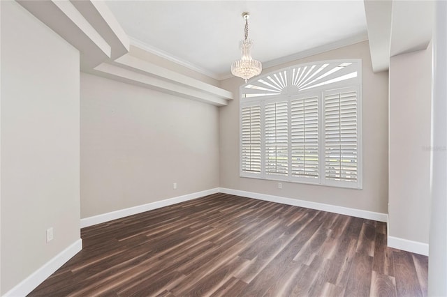 spare room featuring dark hardwood / wood-style floors, crown molding, and an inviting chandelier