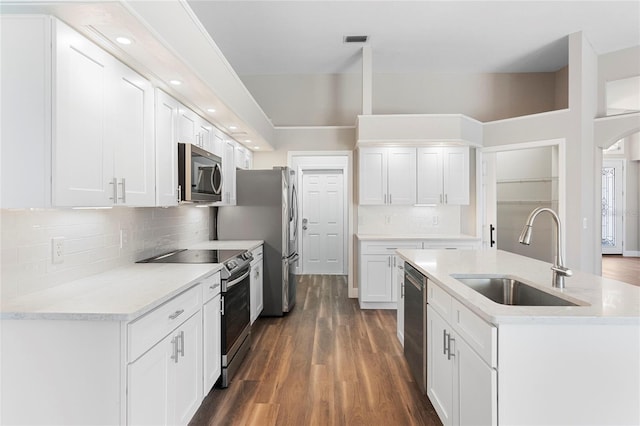 11332 Rivers Bluff Cir, Lakewood Ranch, FL 34202 - kitchen featuring a sink, appliances with stainless steel finishes, dark wood-style floors, white cabinets, and recessed lighting