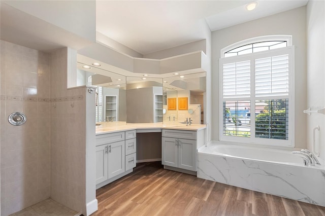 bathroom with vanity, wood-type flooring, and independent shower and bath