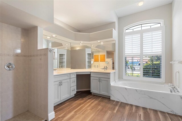 11332 Rivers Bluff Cir, Lakewood Ranch, FL 34202 - full bath featuring healthy amount of natural light, vanity, a bath, wood finished floors, and recessed lighting