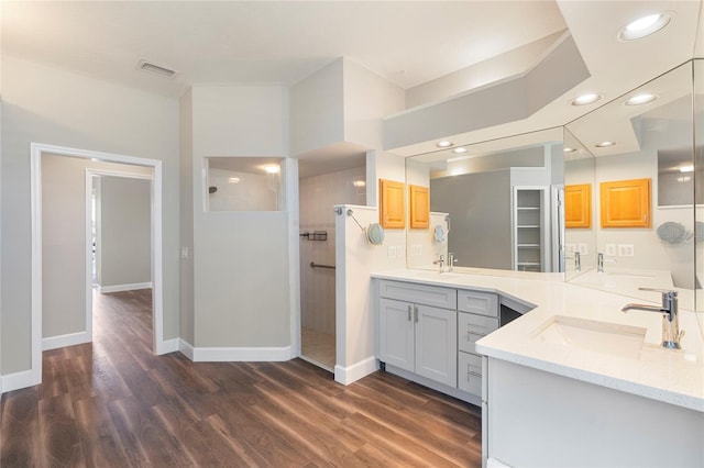 11332 Rivers Bluff Cir, Lakewood Ranch, FL 34202 - full bathroom with walk in shower, wood finished floors, baseboards, two vanities, and recessed lighting