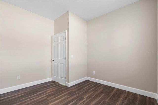 empty room with dark hardwood / wood-style floors