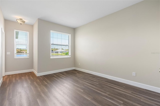 spare room with dark hardwood / wood-style flooring