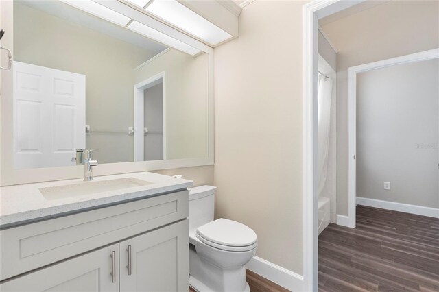 11332 Rivers Bluff Cir, Lakewood Ranch, FL 34202 - full bath with wood finished floors, toilet, vanity, baseboards, and shower / tub combo with curtain
