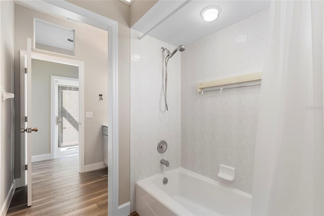11332 Rivers Bluff Cir, Lakewood Ranch, FL 34202 - bathroom featuring baseboards, shower / bathtub combination, wood finished floors, and vanity