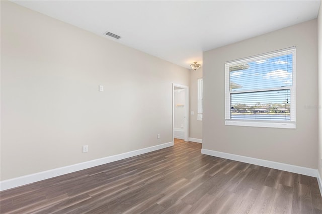 spare room featuring dark hardwood / wood-style floors