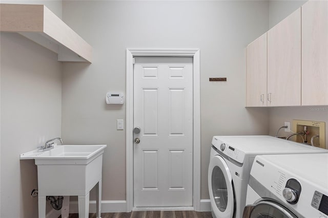 laundry area featuring washer and dryer, dark wood-type flooring, cabinets, and sink