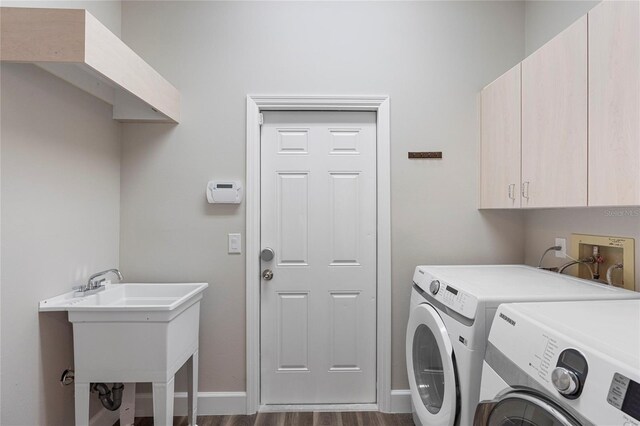 11332 Rivers Bluff Cir, Lakewood Ranch, FL 34202 - clothes washing area with cabinet space, washing machine and dryer, dark wood finished floors, and baseboards