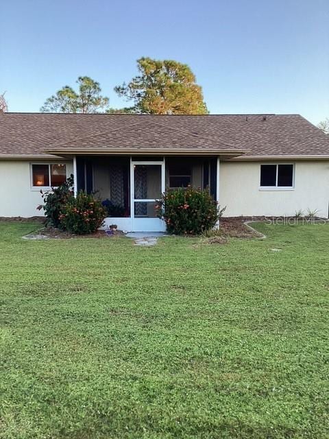 4601 Ulster Ave, North Port, FL 34287 - back of house featuring a yard and stucco siding