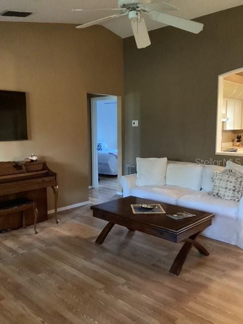 4601 Ulster Ave, North Port, FL 34287 - living room featuring light wood-style flooring, a high ceiling, ceiling fan, and visible vents