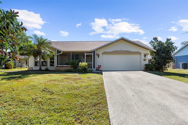 single story home featuring a sunroom, central AC unit, a garage, and a front yard