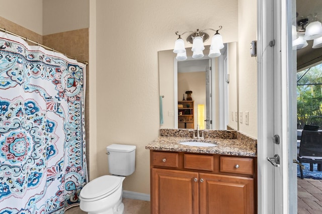 bathroom featuring vanity, walk in shower, and toilet