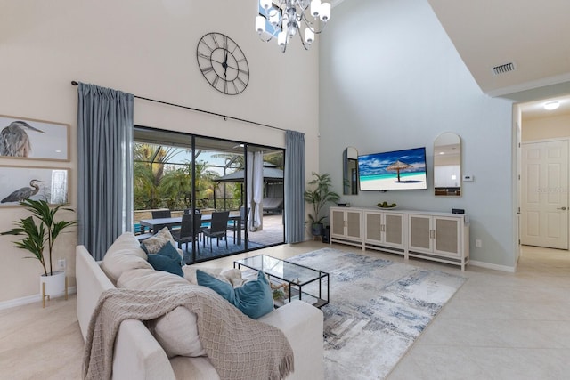 living room with an inviting chandelier and a towering ceiling