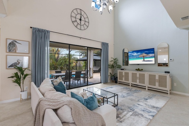 living room with light tile patterned flooring, a towering ceiling, and a chandelier