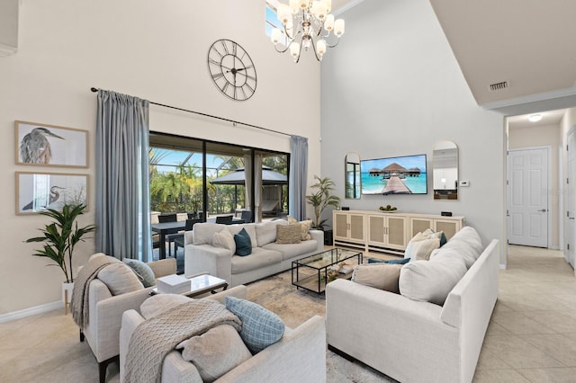 tiled living room featuring a towering ceiling and a chandelier