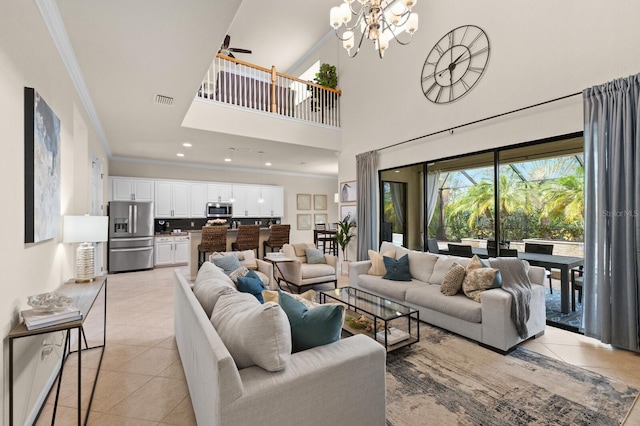 tiled living room with crown molding, ceiling fan with notable chandelier, and a high ceiling