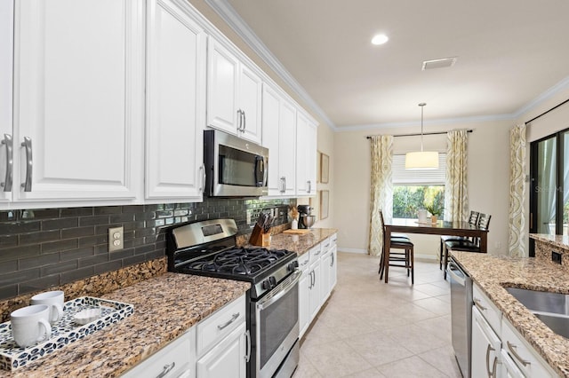 kitchen featuring hanging light fixtures, white cabinetry, and appliances with stainless steel finishes