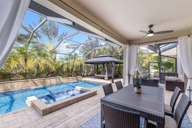 view of swimming pool with pool water feature, outdoor lounge area, a lanai, an in ground hot tub, and a patio