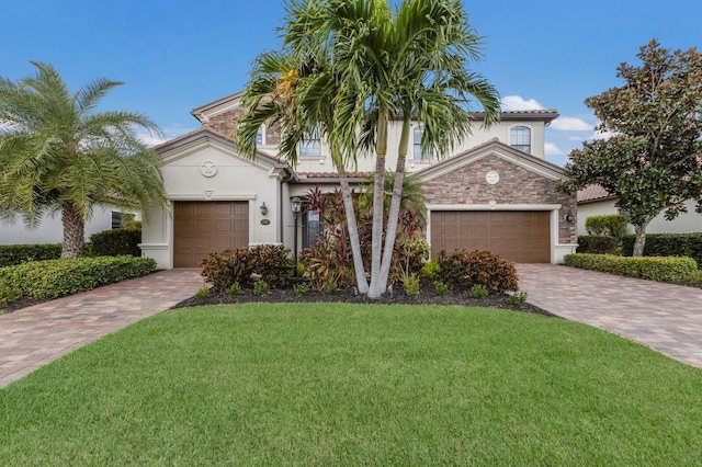 mediterranean / spanish home featuring a garage and a front lawn