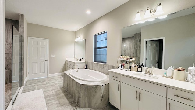 12661 Oak Hill Way, Parrish, FL 34219 - full bathroom with a shower stall, a garden tub, and two vanities