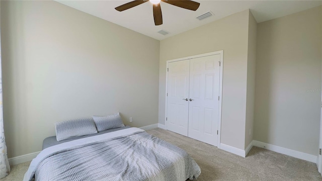 12661 Oak Hill Way, Parrish, FL 34219 - bedroom with light colored carpet, a closet, and a ceiling fan