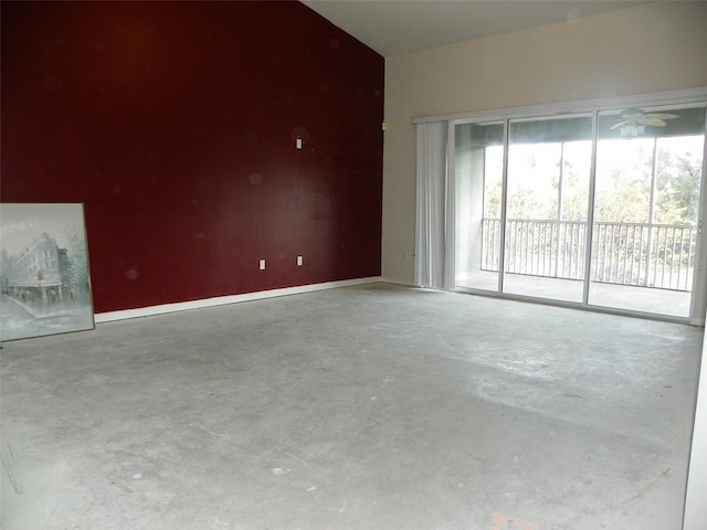 unfurnished living room featuring concrete flooring and ceiling fan