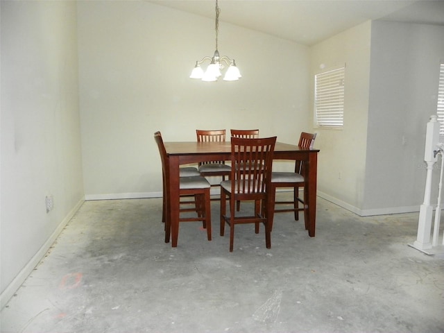 dining room with a notable chandelier and concrete flooring