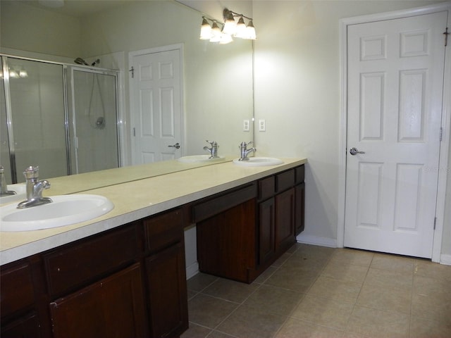 bathroom featuring vanity, tile patterned flooring, and an enclosed shower