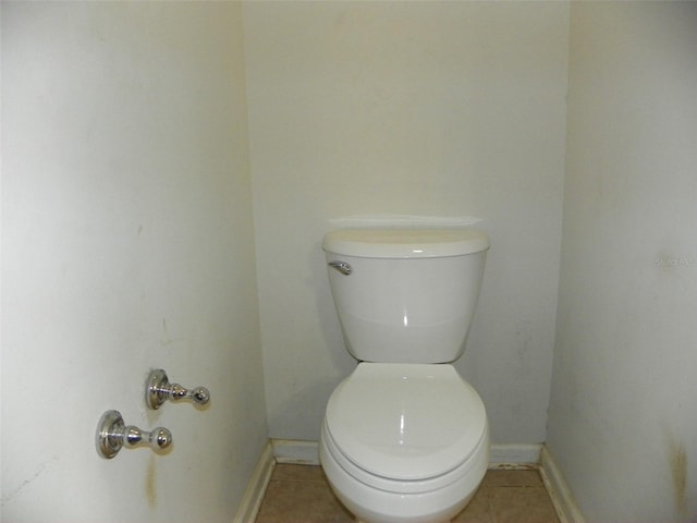 bathroom with toilet and tile patterned flooring