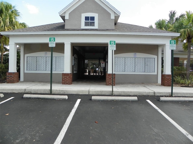 view of parking featuring a mail area