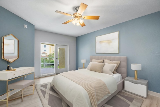 bedroom featuring ceiling fan, light hardwood / wood-style flooring, and access to exterior