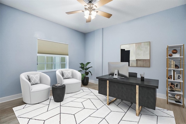 home office with wood-type flooring and ceiling fan