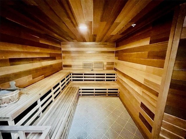 view of sauna / steam room featuring wood walls and wooden ceiling