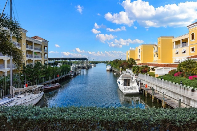 dock area with a water view and a balcony