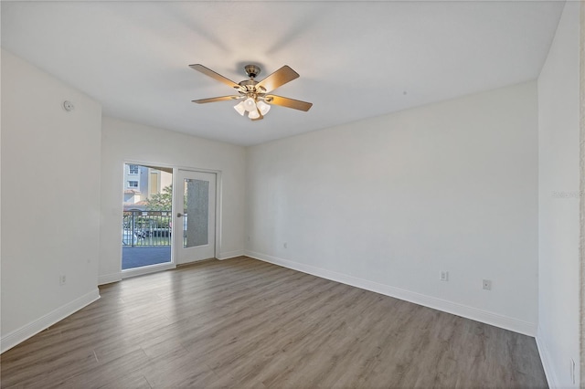 14041 Bellagio Way Unit 214, Osprey, FL 34229 - spare room featuring baseboards, ceiling fan, and wood finished floors