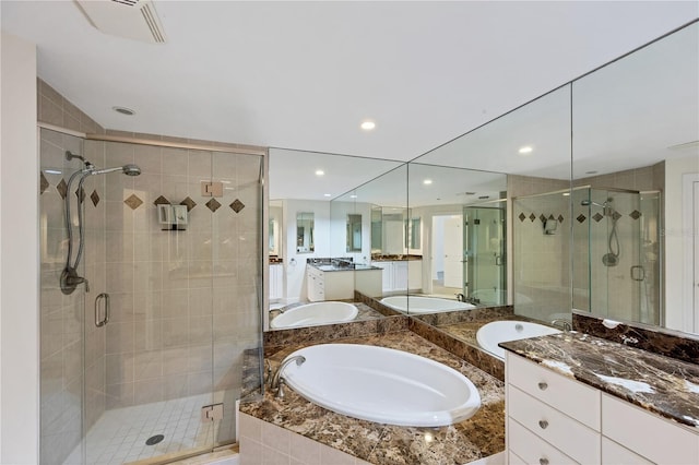 14041 Bellagio Way Unit 214, Osprey, FL 34229 - full bath featuring a sink, recessed lighting, two vanities, a shower stall, and a garden tub