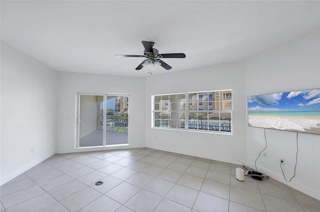 14041 Bellagio Way Unit 214, Osprey, FL 34229 - spare room featuring light tile patterned flooring, ceiling fan, and baseboards
