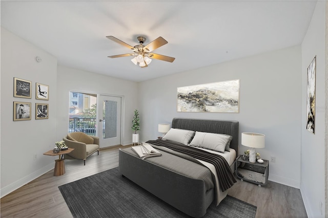 14041 Bellagio Way Unit 214, Osprey, FL 34229 - bedroom with baseboards, a ceiling fan, wood finished floors, and access to exterior