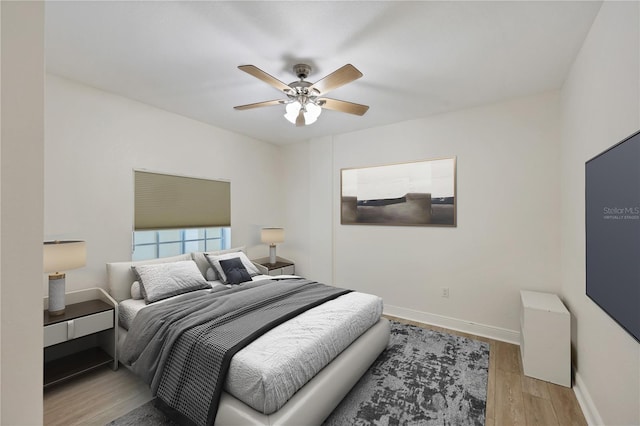 14041 Bellagio Way Unit 214, Osprey, FL 34229 - bedroom with a ceiling fan, baseboards, and light wood-type flooring