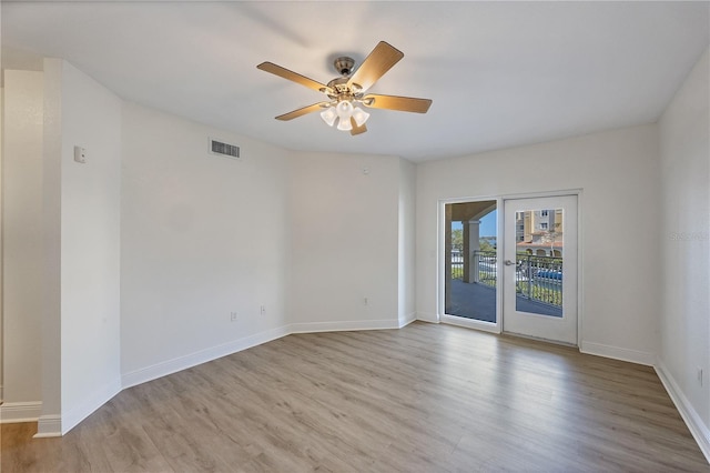 14041 Bellagio Way Unit 214, Osprey, FL 34229 - spare room featuring a ceiling fan, baseboards, visible vents, and wood finished floors